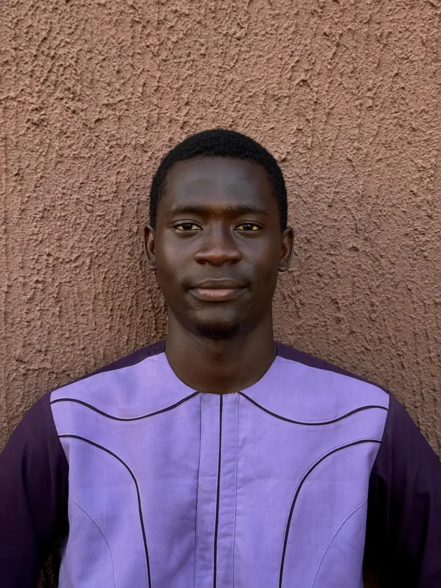 Olabisi Adigun standing against a textured wall
